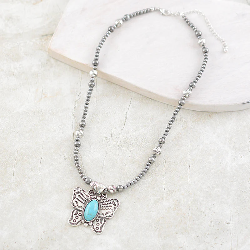 fashion silver & turquoise butterfly necklace on white background