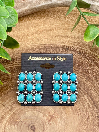 Turquoise earrings on a 'Accessorize in Style' card with a natural background