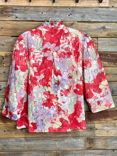 Floral-patterned jacket hanging on a wooden wall