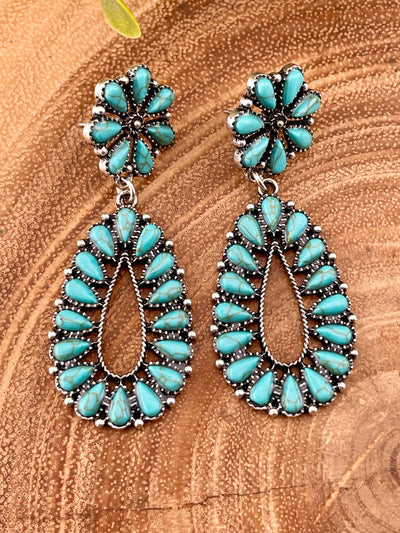 blue earrings on a wooden background