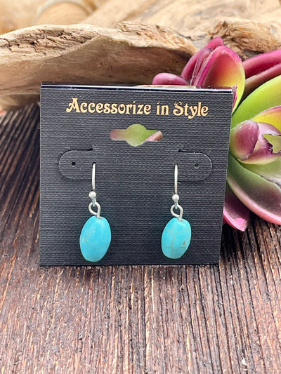 Turquoise earrings on a 'Accessorize in Style' card with succulents in the background