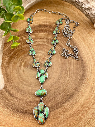 turquoise cluster necklace on wooden background