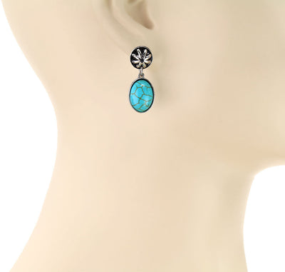 Turquoise earrings on a mannequin