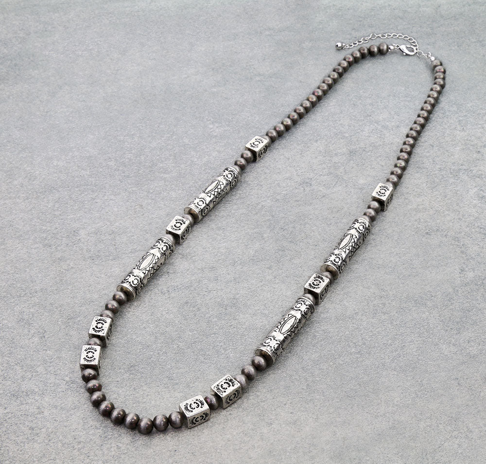 Necklace with brown beads and silver accents on a gray background