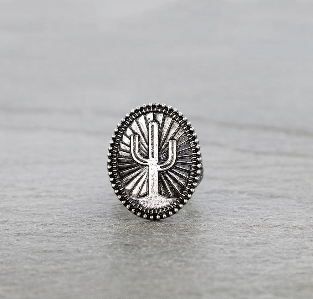 silver cactus ring on gray background