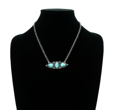 turquoise 3 stone necklace on a black jewelry bust