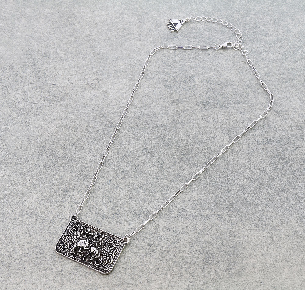 Silver necklace with a rectangular pendant on a gray background
