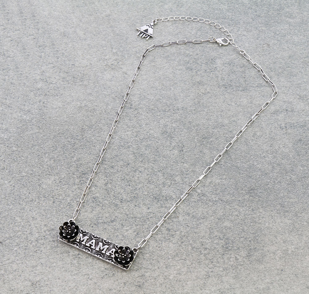 Silver necklace with 'MAMA' pendant on a gray background