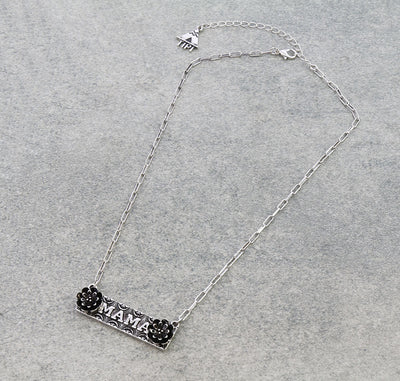 Silver necklace with 'MAMA' pendant on a gray background