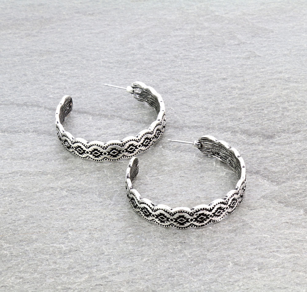 silver hoop earrings on a gray background