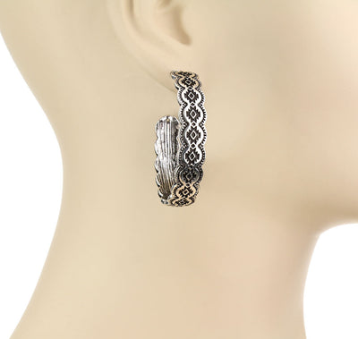 Silver hoop earring on a mannequin ear
