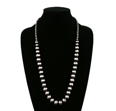Pearl necklace on a black mannequin with 'Blue Tortoise' branding.