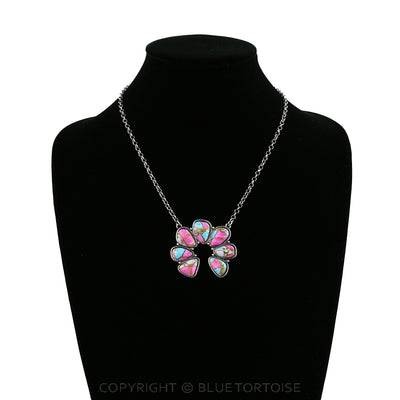 Necklace with a pink and turquoise pendant on a black mannequin.