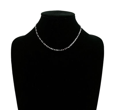 Silver chain necklace on a black mannequin bust.