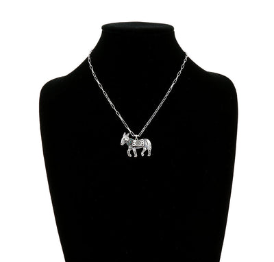 Necklace with a donkey pendant on a black mannequin bust.