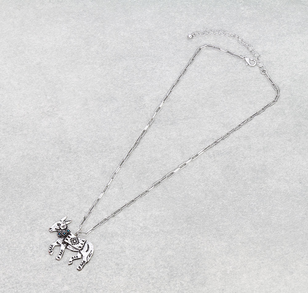 Silver necklace with a donkey pendant on a light gray background