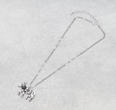 Silver necklace with a donkey pendant on a light gray background