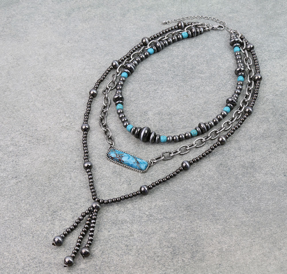 Multistrand necklace with turquoise beads on a gray background