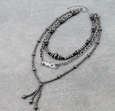 Multistrand beaded necklace on a gray background