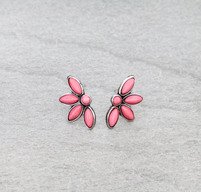 A pair of silver post earrings with pink accents, designed in a floral pattern, displayed on a gray background
