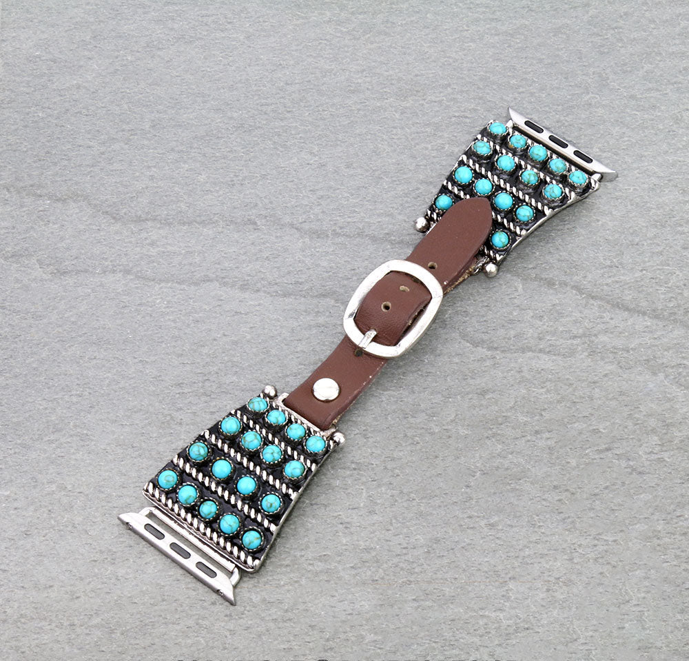 Watch band with turquoise stones and brown leather strap on a gray background