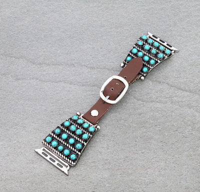 Watch band with turquoise stones and brown leather strap on a gray background
