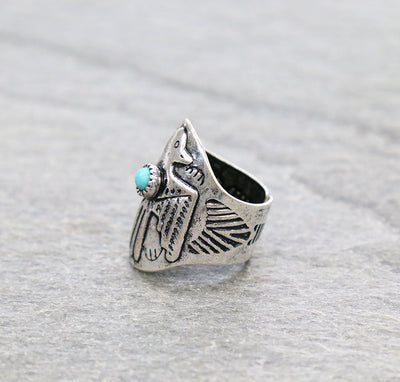 Silver ring with a turquoise stone on a gray background