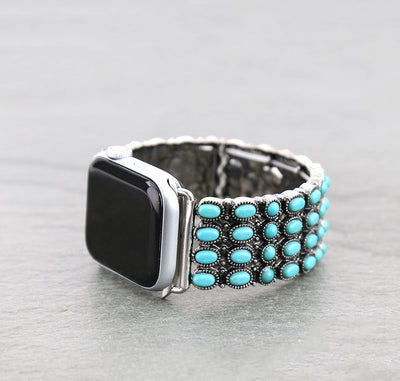Silver watch with turquoise accents on a gray background