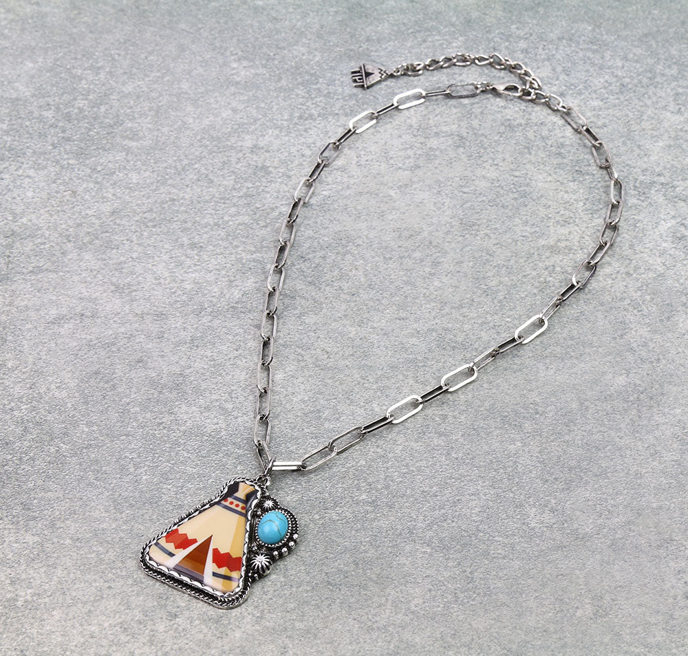 Necklace with a pendant featuring a Native American design on a gray background