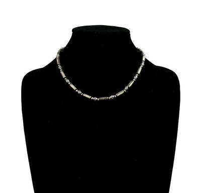 Necklace on a black mannequin with a white background