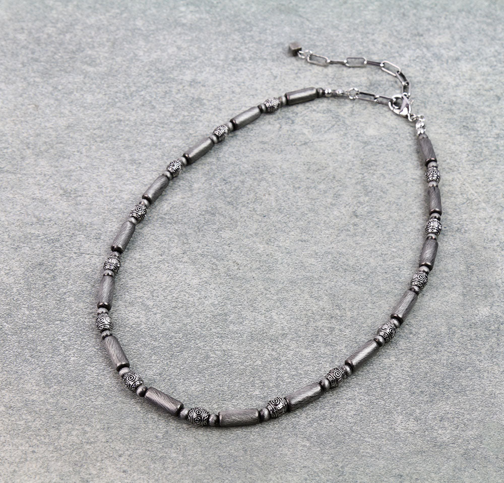 Necklace with gray beads on a gray background