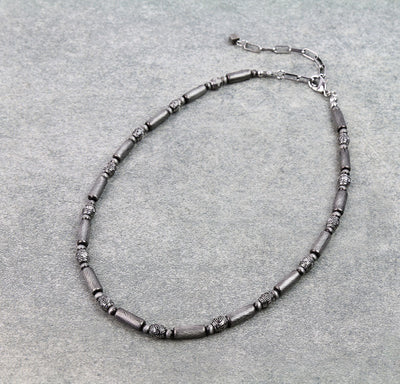 Necklace with gray beads on a gray background