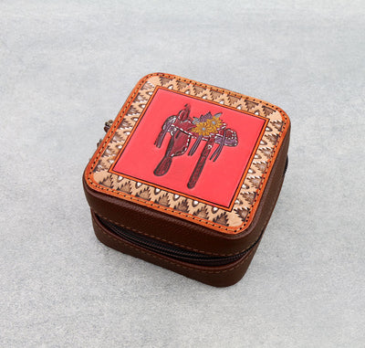 Small brown leather case with red top featuring a horse design on a light gray background.