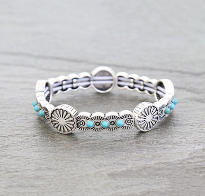 silver & turquoise stretch bracelet on a gray background