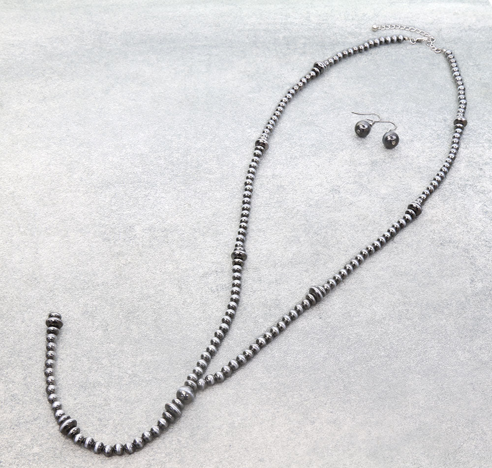 Beaded necklace and earrings on a light gray background with 'Blue Tortoise' branding.