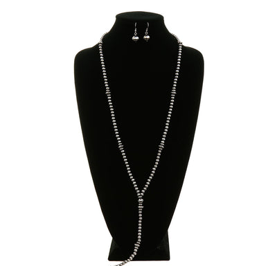 Jewelry set with necklace and earrings on a black mannequin against a white background, branded 'Blue Tortoise'.