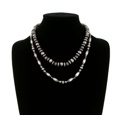 double strand silver necklace on a bust