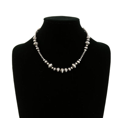 silver bead necklace on a mannequin bust