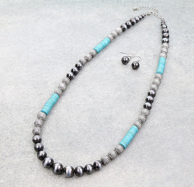 Necklace with turquoise accents and matching earrings on a gray background, branded 'Blue Tortoise'.