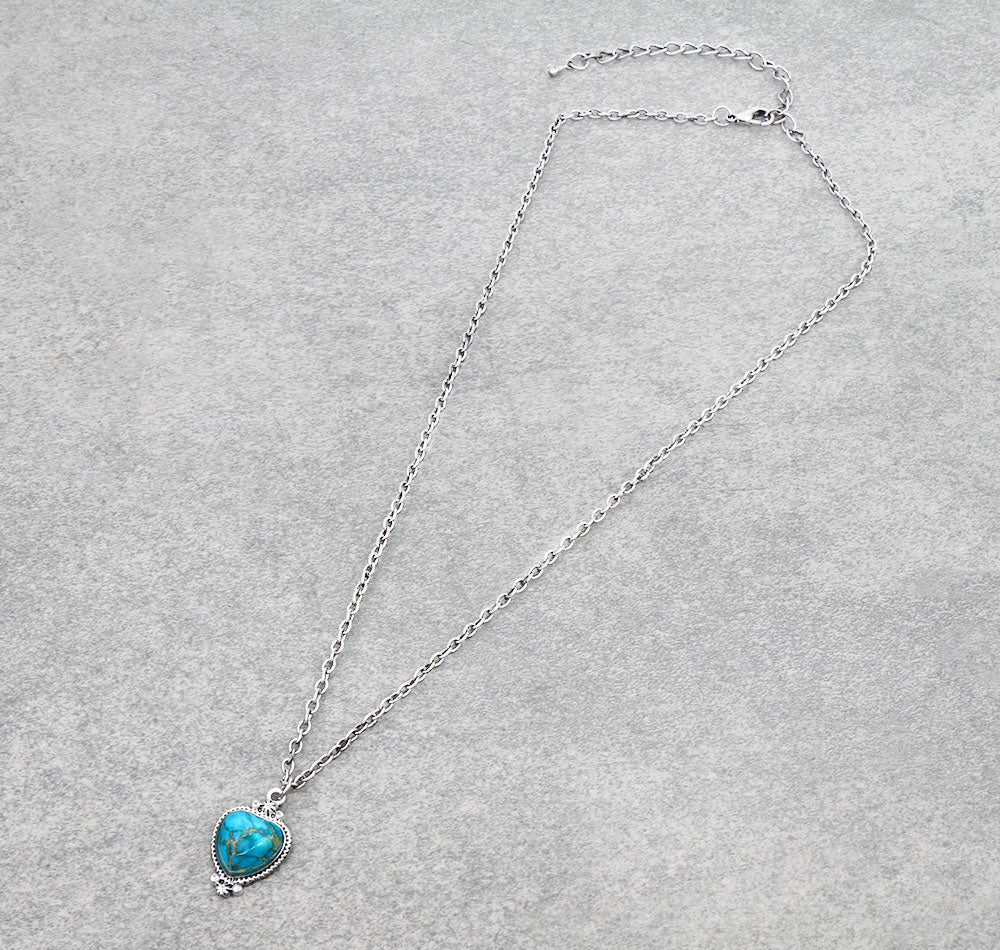 Necklace with a turquoise pendant on a gray background