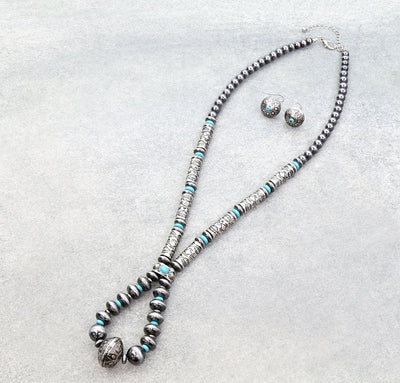 silver & turquoise loop necklace with coordinating earrings on a gray background