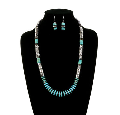 silver & turquoise bead necklace and earrings on a black bust