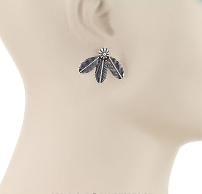 Feather-shaped earring on a mannequin ear