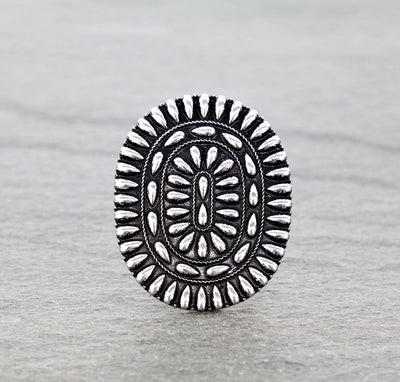 silver Concho ring on gray surface