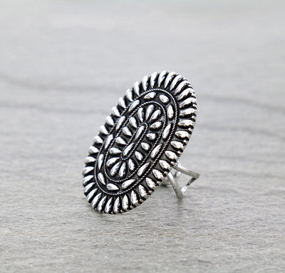 silver Concho ring on gray surface