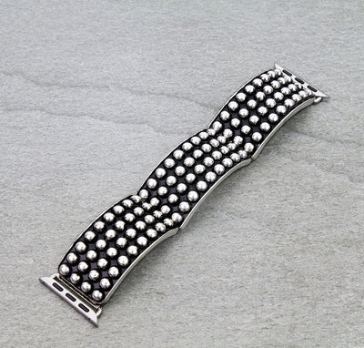 Silver watch strap with textured design on a gray background