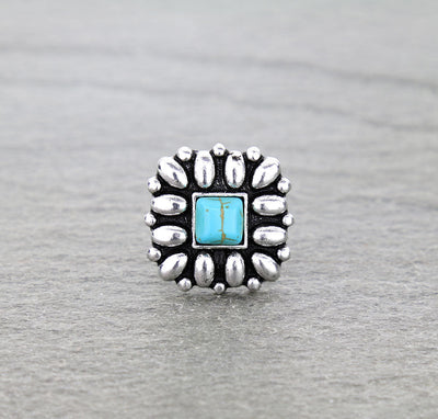 Silver and turquoise ring on a gray background