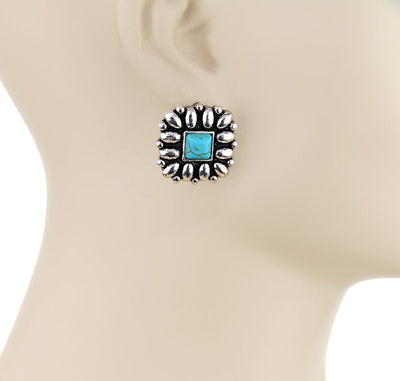 Turquoise stone earring on a mannequin with 'Blue Tortoise' branding.