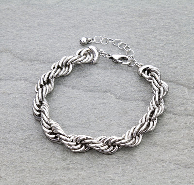 Silver braided bracelet on a gray background