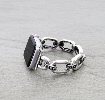 Silver chain watch band on a gray surface